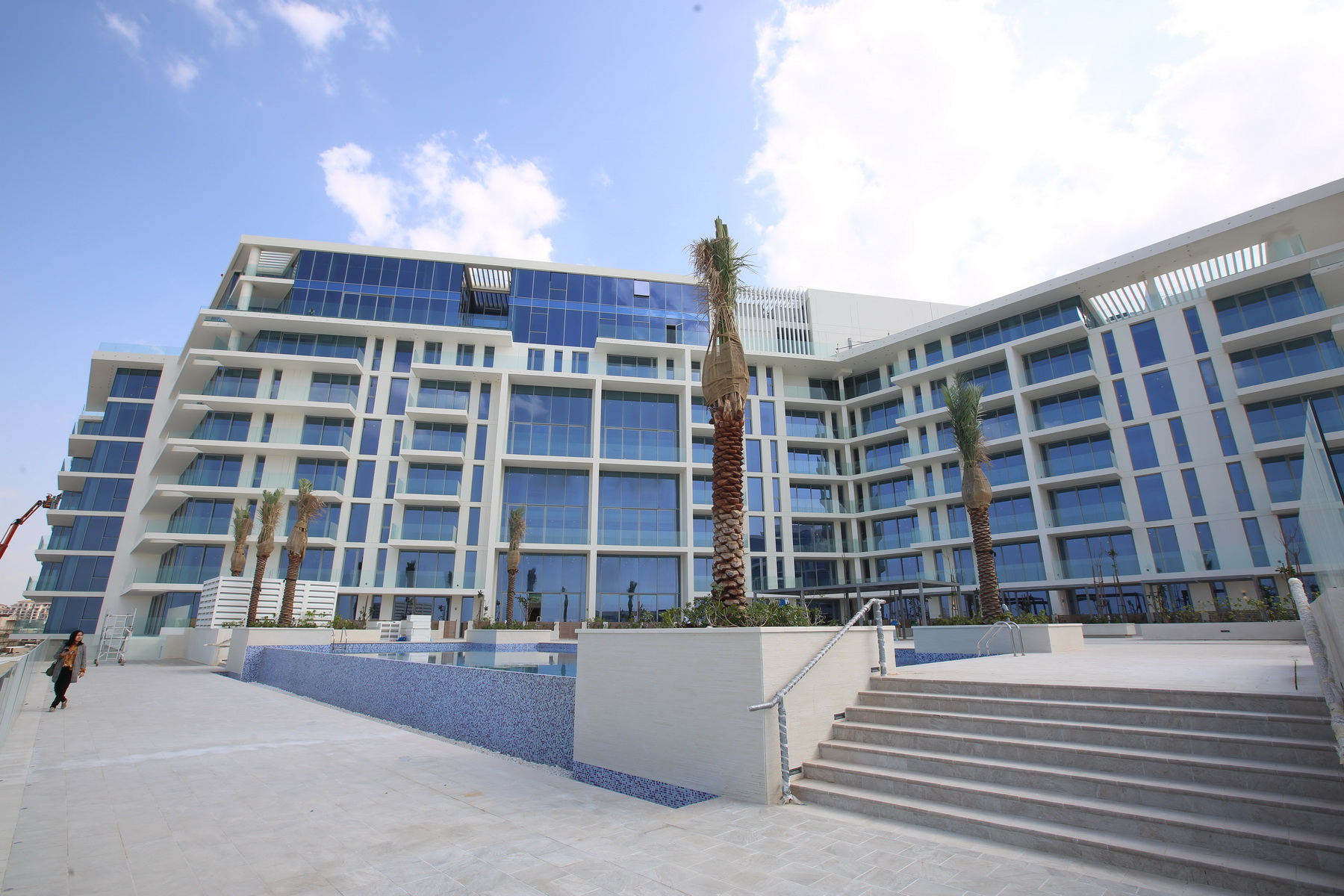 Private penthouse rooftop with infinity pool, sun deck, and panoramic sea and museum views